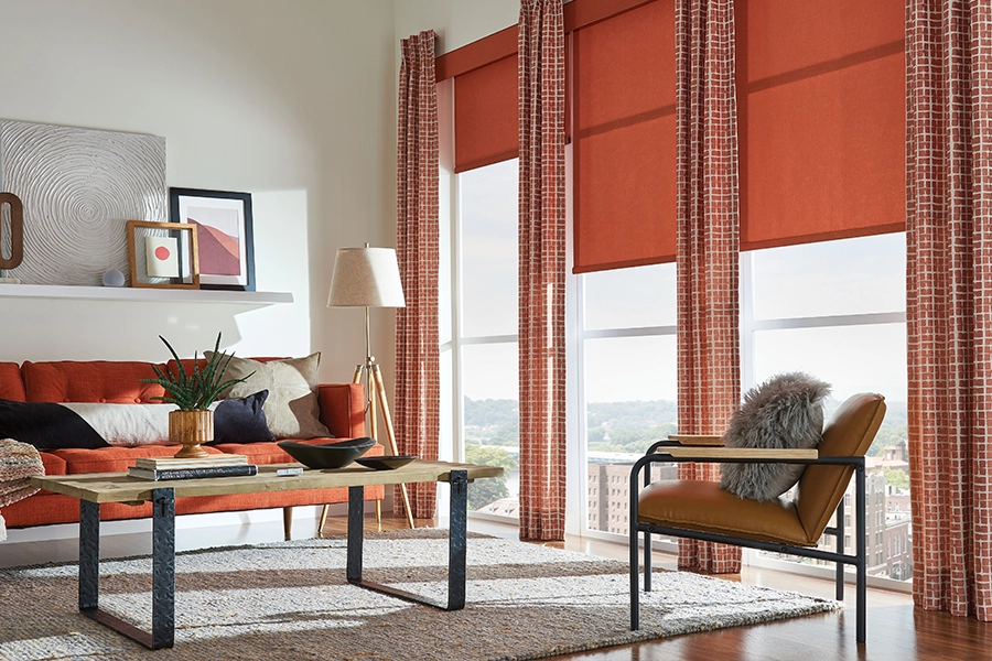 Put lined drapes on very sunny windows to protect your home from sun glare and hot UV rays. Orange patterned drapes with orange shades on tall living room windows