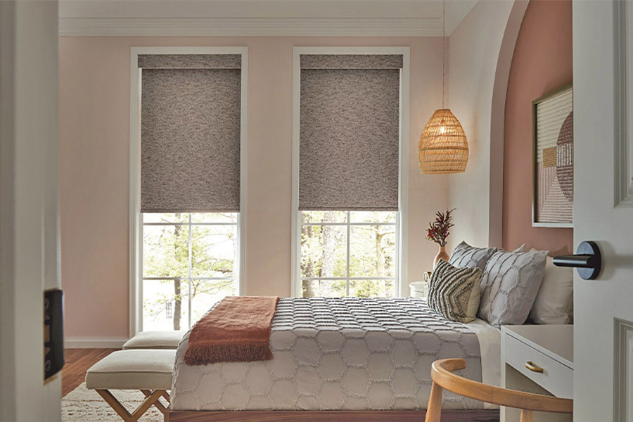 Get a better night's sleep with roller shades blocking outside noise and light that come through your window. A bedroom with a bed and a window