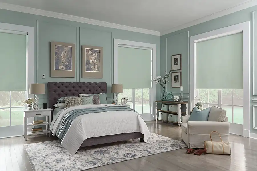 Light green window shades in a green and beige bedroom