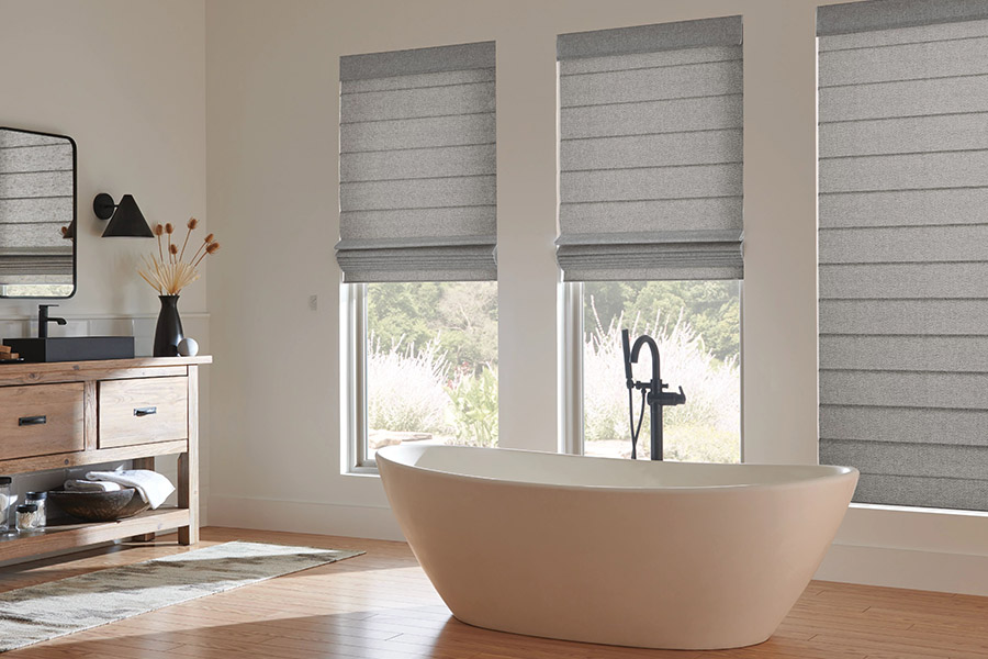 Quality window shades last many years, even in kitchens and bathrooms. Gray Roman shades on bathroom windows