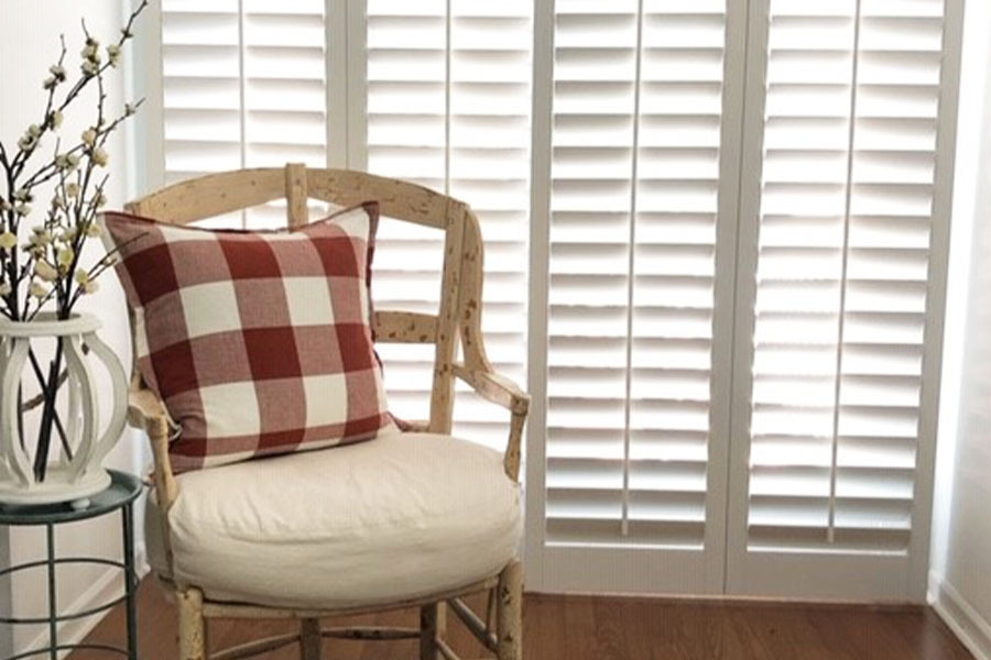 Choose how open or closed you want your sliding door shutters to be for light management. Photo credit: Finishing Touch Decor By Jenny White interior shutters on a sliding door in a sitting area
