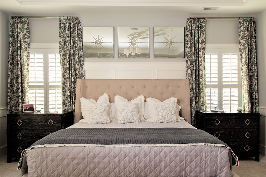 Talk to your window treatment consultant if you like the look and functionality of divider rails for your plantation shutters. White interior shutters with divider rails on bedroom windows