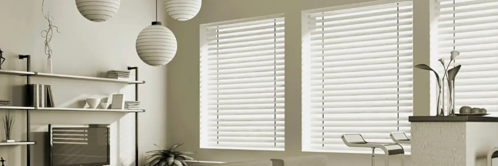 Bright white window blinds on windows in a white living room