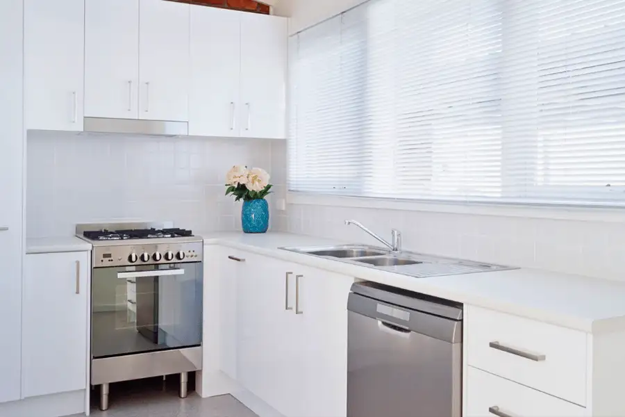 White faux blinds in a bright modern kitchen