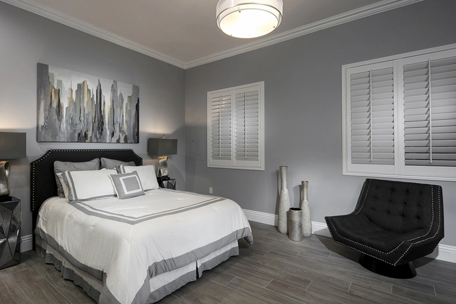 Close your custom Polywood shutters to beat the heat and keep your bedroom cool. White Polywood shutters on bedroom windows